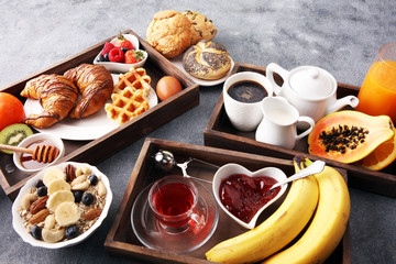 Breakfast served with coffee, orange juice, croissants and fruits. Balanced diet.