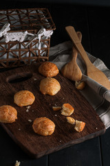 Small snack cheese bread with black wooden