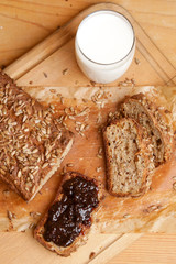 Homemade fresh baked bread with jam and glass of milk