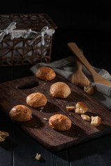 Obraz na płótnie Canvas Small snack cheese bread with black wooden