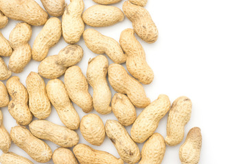 Unshelled peanuts top view isolated on white background left side.