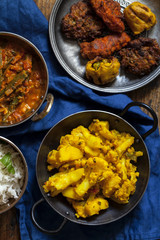 Indian meal with aloo gobi, okra curry, rice and pakoras