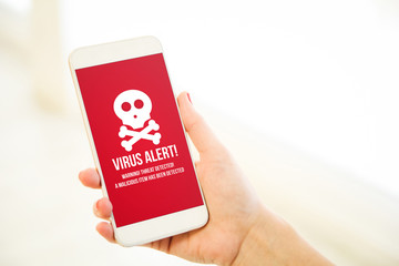 Woman holding a pink gold blank smartphone virus alert