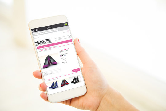 Woman holding a pink gold blank smartphone online shop
