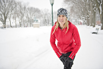 Blond woman running outdoors on a cold winter day