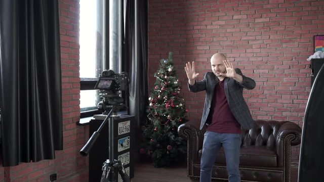 Young man blogger hypnotist recording himself on camera for online internet vlog for social media