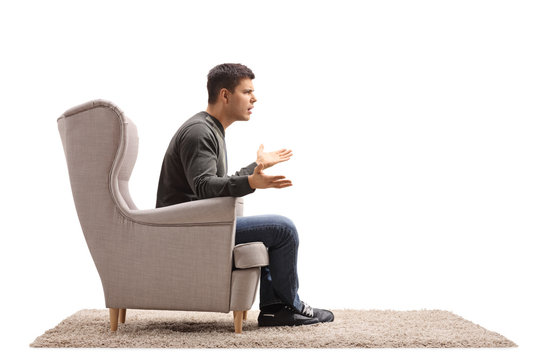 Young guy sitting in an armchair and arguing
