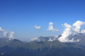 Fototapeta na wymiar The rocky mountains among the clouds