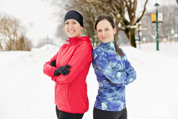 Group of friends enjoying jogging in the snow in winter