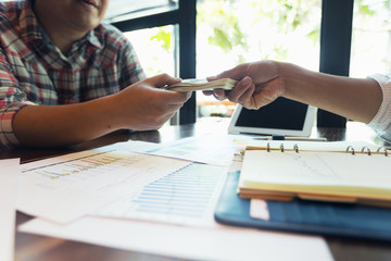 Businessmen are receiving dividends from investments.