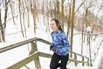 Woman Running in Snowy Park in winter season