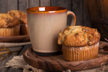 Banana Nut Muffin and Coffee Cup on Rustic Wooden Plate