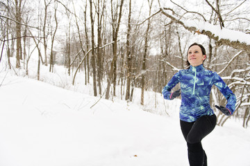 Woman Running in Snowy Park in winter season