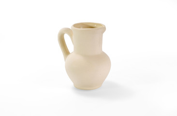 Little unpainted ceramic jug on white background