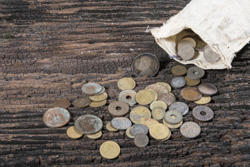 coins from various years on old wooden.