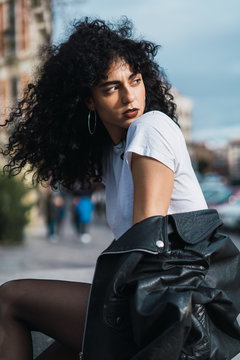 Curly woman posing in city