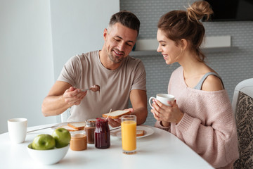 Fototapeta na wymiar Portrait of a smiling loving couple having breakfast