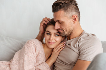 Portrait of a young loving couple resting on a couch