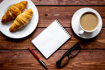 Business breakfast with coffee and croussant top view