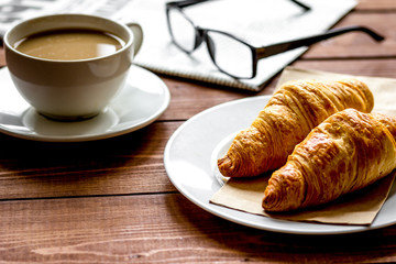 Businessman morning cup of coffee at home with newspaper