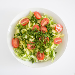 White round plate with vegetable salad. Raw food