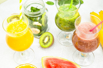 Tropical Healthy Smoothie with fresh kiwi, banana, watermelon and spinach on a light background, top view. Diet, Detox, Healthy Dessert Concept