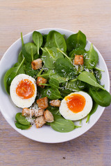 Boiled egg with toasted bread, spinach and parmesan cheese for breakfast. Breakfast meal. View from above, top, vertical