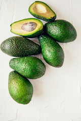 Group of organic fresh ripe and unripe avocados isolated on white background