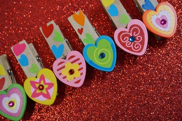 Wooden colorful paper clips in the shape of hearts - Valentine's background
