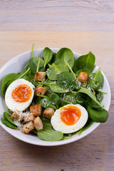 Boiled egg with toasted bread, spinach and parmesan cheese for breakfast. Breakfast meal, vertical