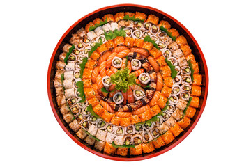 Fototapeta na wymiar different types of sushi are stacked on a round dish on a white background. A variety of Japanese sushi buns.