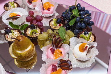 Red and blue grapes on a tray with pear and apple. Grapes on a tray.