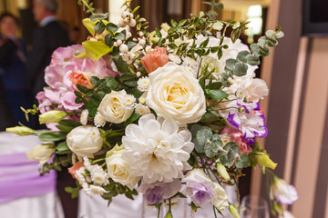 A wedding bouquet is on the table in the background of the hall. Bridal bouquet.