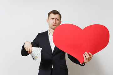 Dissatisfied man with big red heart, bundle of cash money dollars isolated on white background. Copy space for advertisement. St. Valentine's Day, International Women's Day, birthday holiday concept.