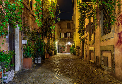 Night view of old cozy street in Trastevere in Rome, Italy