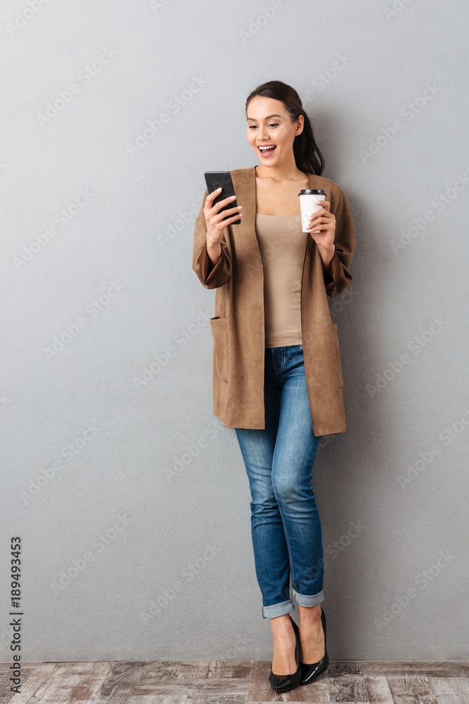 Poster full length of a cheerful young asian woman