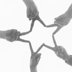  Teamwork, unity and friendship concept. Hands joining in a star shape.