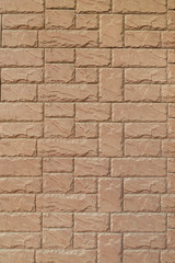 wall from a yellow brick of a stone with a regular laying