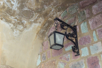 Fototapeta na wymiar An antique lantern on the wall of the Château de la Napoule castle in Mandelieu-la-Napoule, France, Europe