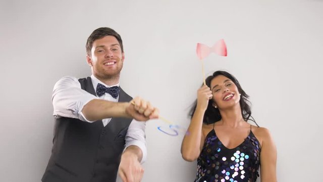 couple with party props having fun and dancing