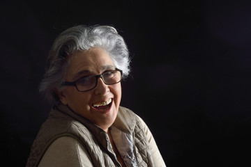 portrait of a senior woman on black