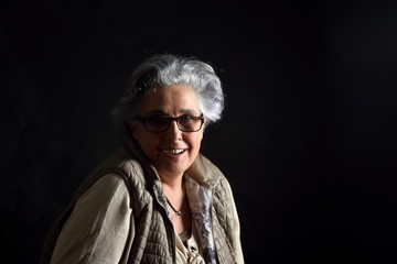 portrait of a senior woman on black