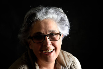 portrait of a senior woman on black