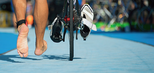 Triathlon bike the transition zone,detail of the bare feet - obrazy, fototapety, plakaty