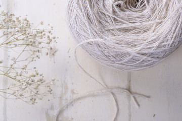 Precious linen yarn on a white table