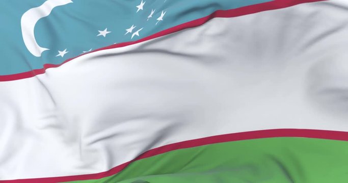 Flag of Uzbekistan waving at wind in slow with blue sky, loop