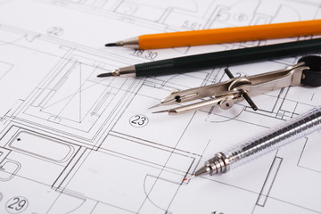 Architectural project, engineering tools on table.