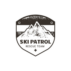 Vintage hand drawn mountain ski patrol emblem. Rescue team patch. Mountains stamp. Monochrome, grunge letterpress effect. Stock vector retro badge illustration isolated on white background