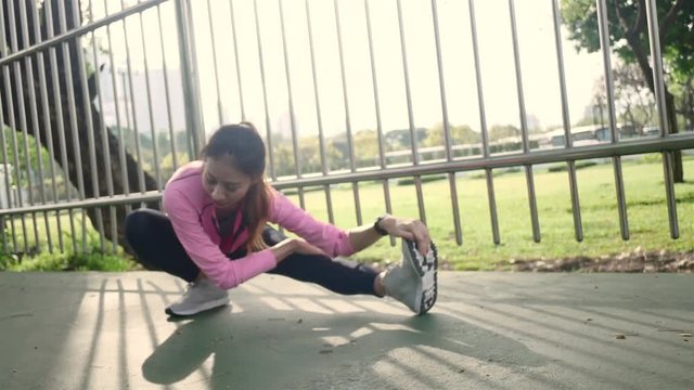Fitness sport girl fashion sportswear doing yoga fitness exercise in street. Fit young asian woman doing training workout in morning. Young happy asian woman stretching at park after running workout.