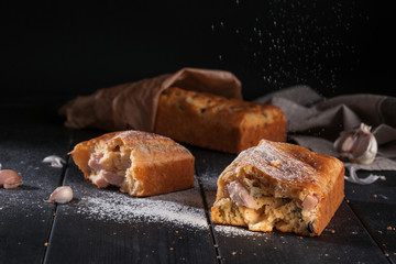 Homemade mini bread with fillers on dark wooden surface